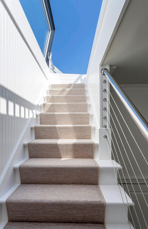 door style rooflight installed above a white staircase with a brown carpet runner